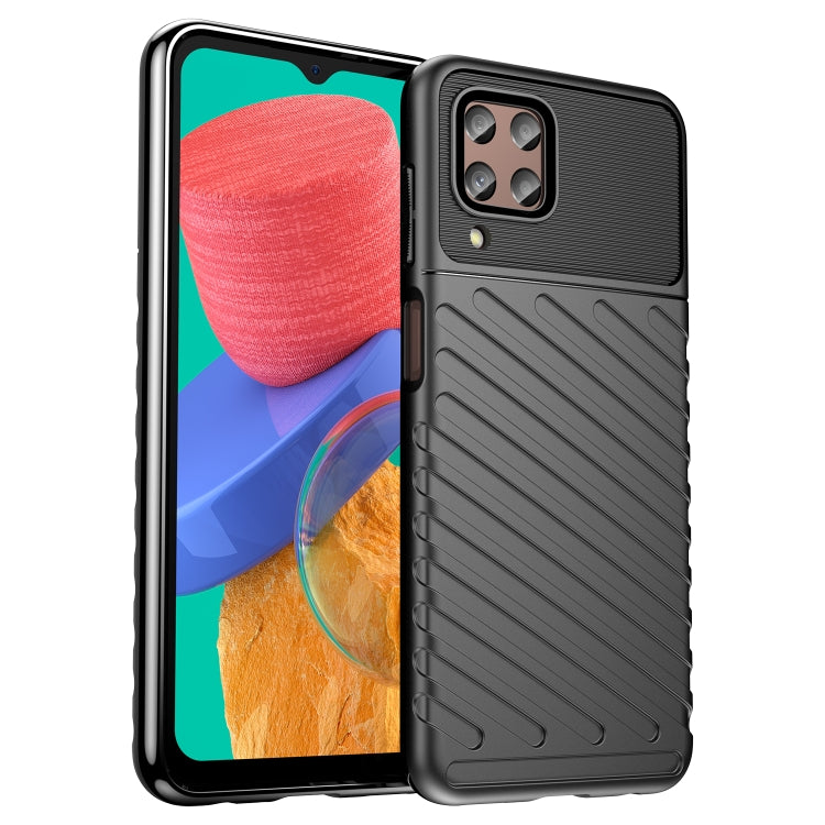 Black shockproof TPU phone case with ribbed back and camera cutout, front phone visible