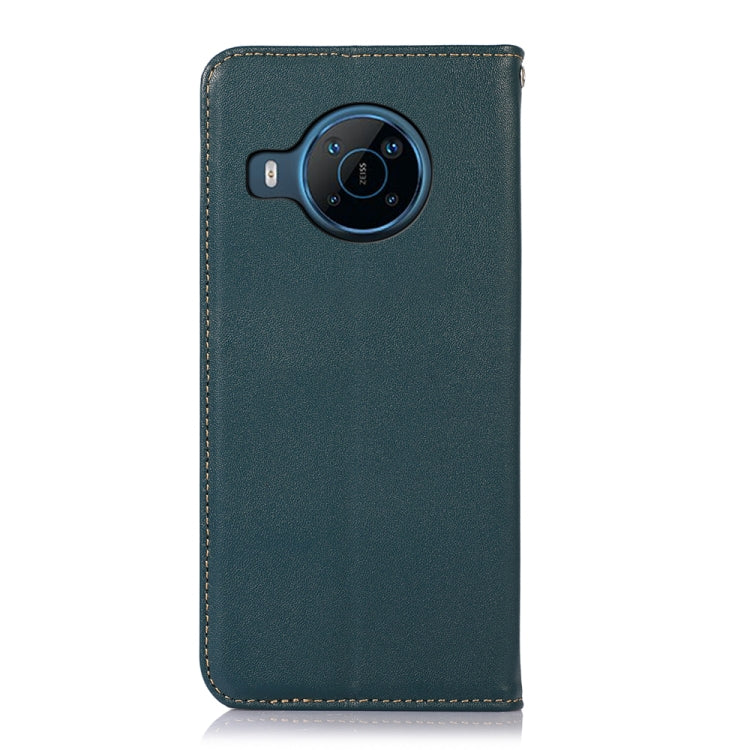 Green leather phone case with round camera module cutout and stitched border.