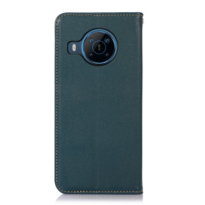 Green leather phone case with round camera module cutout and stitched border.