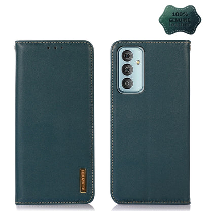 Green leather phone case with triple-lens camera cutout and genuine leather badge.