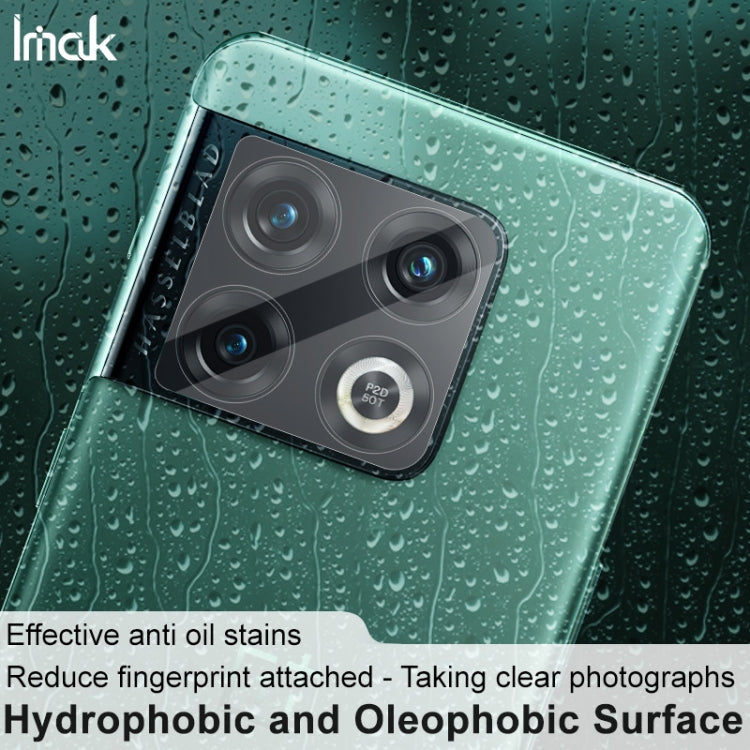 Clear rear camera lens tempered glass film on teal phone back, droplets on surface