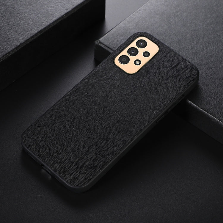 Wood-texture PU phone case, black, angled view showing camera cutout.