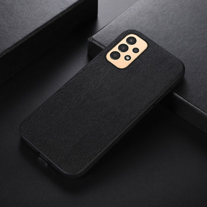 Wood-texture PU phone case, black, angled view showing camera cutout.