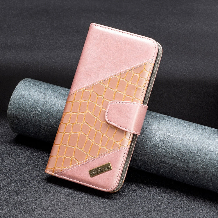 Rose gold and tan crocodile-texture leather phone case with snap strap and brand patch