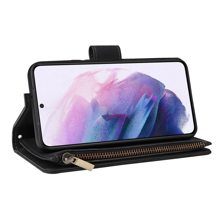 Black leather phone wallet case with zipper pouch, holding a phone