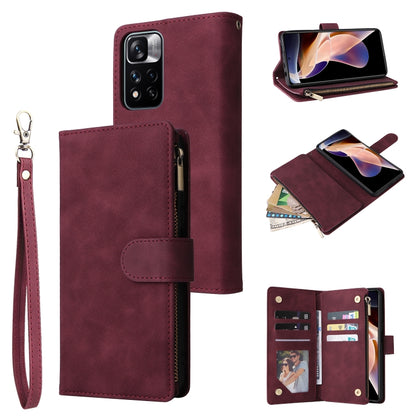 Wine red leather phone wallet case with wrist strap, zipper closure, and multiple pockets
