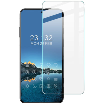 Tempered glass screen protector film on smartphone with blue wallpaper and icons visible