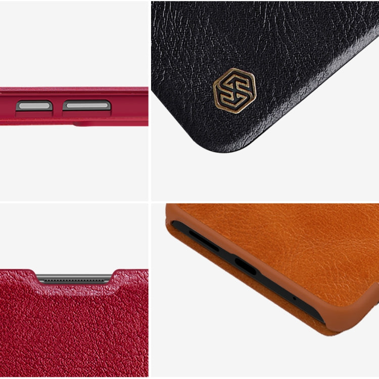 Corner detail of leather-texture phone case with embossed logo and cutouts