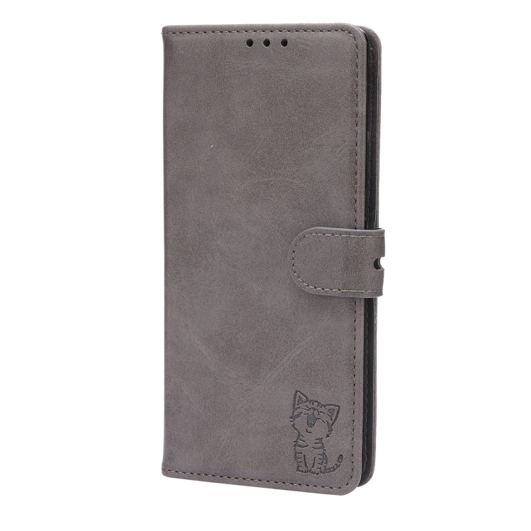 Grey folio phone case with magnetic-style flap and side buckle, cat embossed.