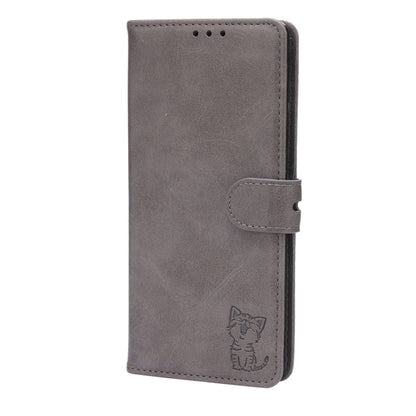 Grey folio phone case with magnetic-style flap and side buckle, cat embossed.
