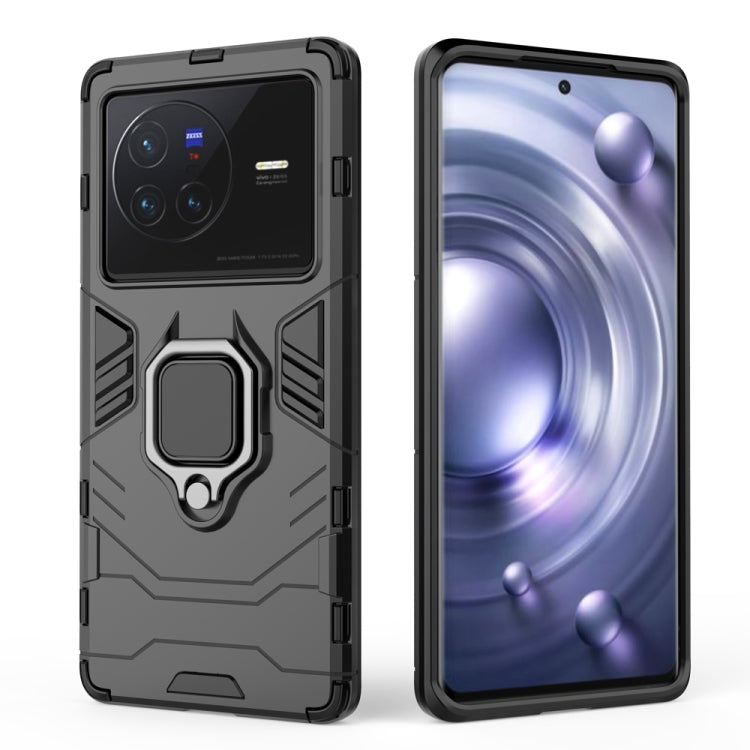 Shockproof phone case with magnetic ring holder, dark gray/black, raised camera cover.