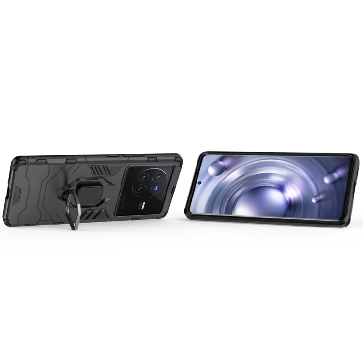 Shockproof phone case with magnetic ring holder, dark gray/black, side profile view.