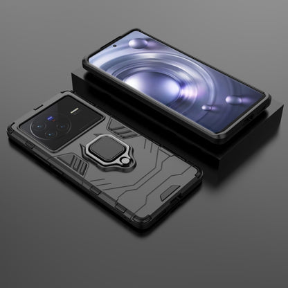 Shockproof phone case with magnetic ring holder, dark gray/black, phone and case together.