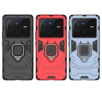 Shockproof phone case with magnetic ring holder in black, red, and light blue variants.