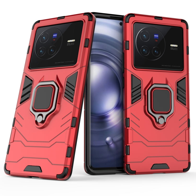 Shockproof phone case with magnetic ring holder, red, rugged armor design with cutouts.