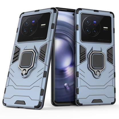 Shockproof phone case with magnetic ring holder, light blue/gray, textured rugged frame.