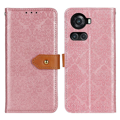 Pink embossed floral flip phone case with camera cutout, tan clasp strap