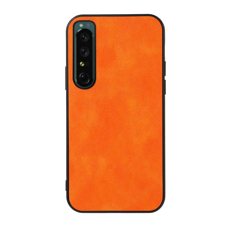 Two-tone PU litchi-texture phone case, orange; full back with camera module cutout.