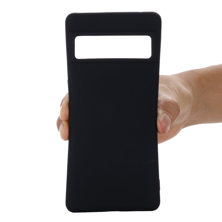 Black liquid silicone shockproof phone case held in hand, front cutout visible