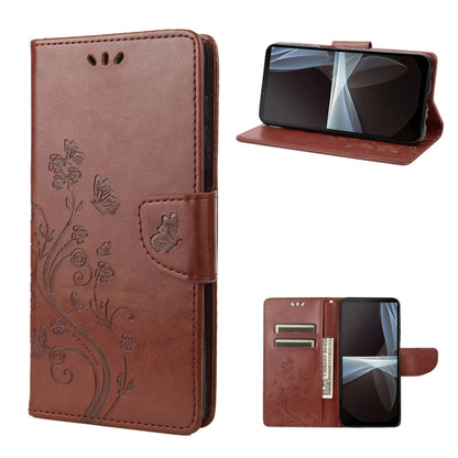 Brown embossed butterfly flip leather phone case, front and open view with stand