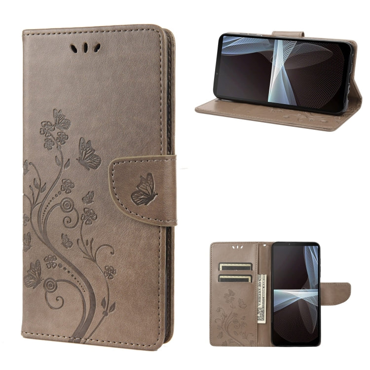 Gray embossed butterfly flip leather phone case, front and open view with stand