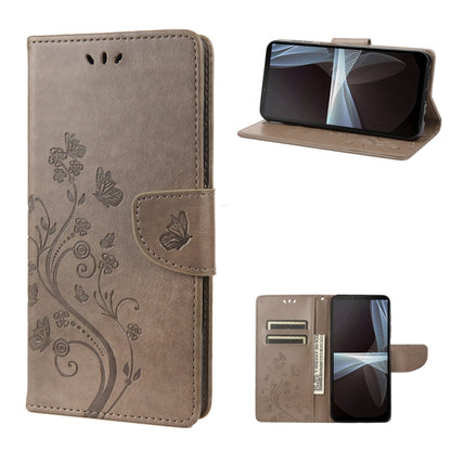 Gray embossed butterfly flip leather phone case, front and open view with stand