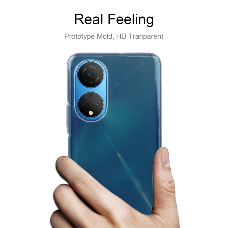 Clear TPU phone case held in hand with camera opening visible