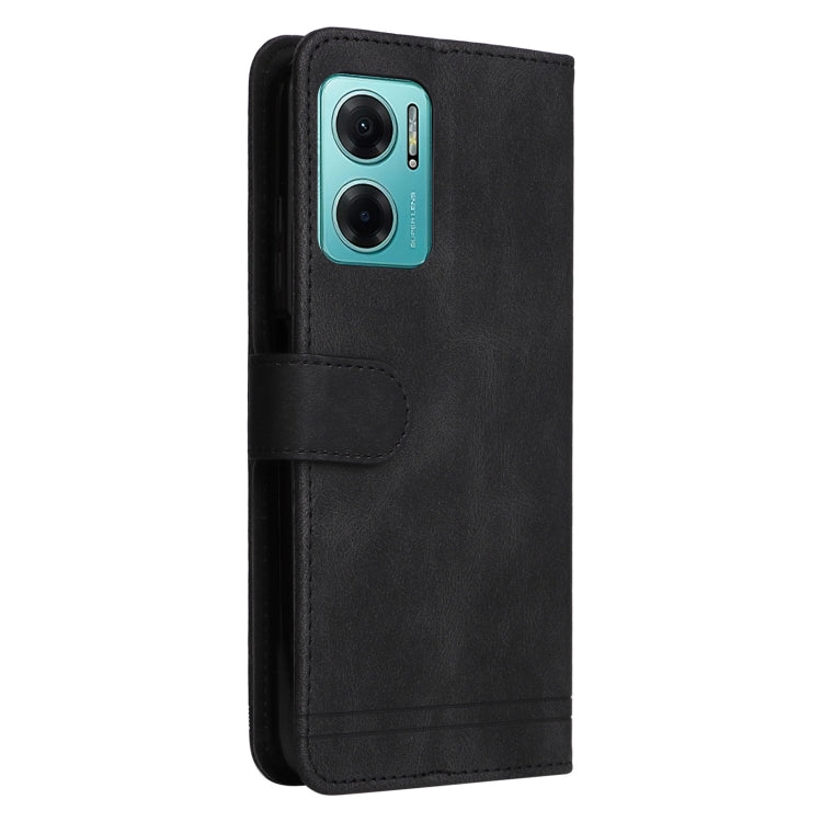 Black leather wallet phone case with camera cutout and fold-over strap