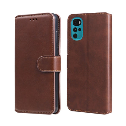 Brown leather flip phone case with magnetic flap, side strap, and camera cutout.