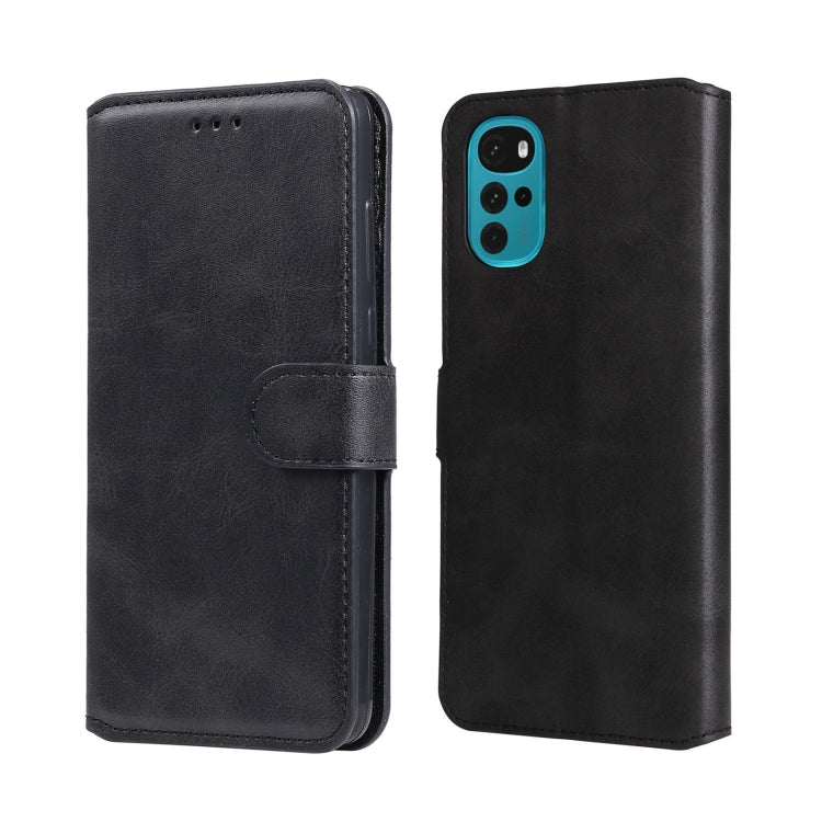 Black leather flip phone case with side strap and camera cutout on back.