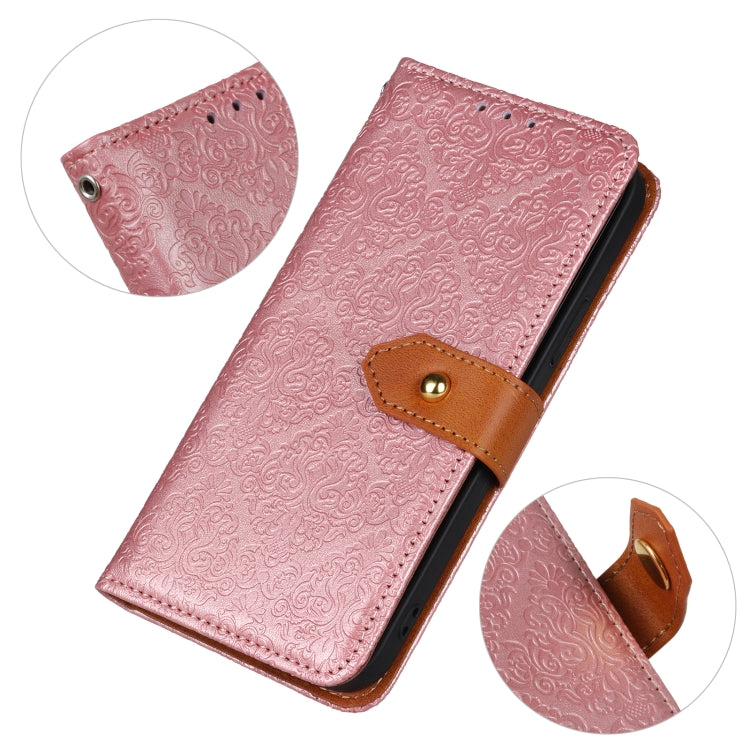 Pink embossed floral flip phone case with brown magnetic clasp, side close-up