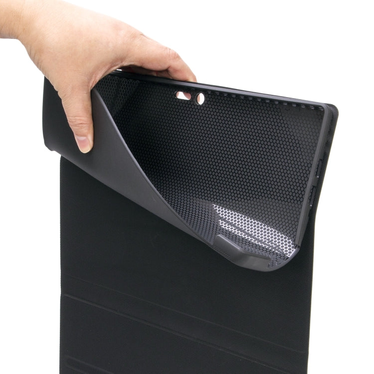 Hand holding dark gray tablet case with textured back and speaker-style grille