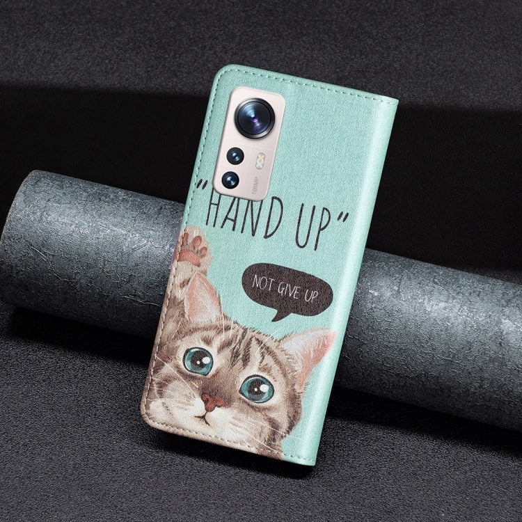 Light blue phone case with kitten face, visible camera cutout, and “HAND UP” quote