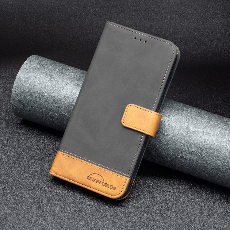 Leather phone case, dark gray with tan magnetic strap and stitched bottom trim.