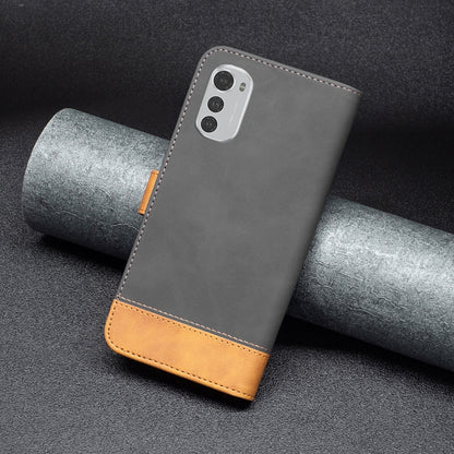 Leather phone case back, dark gray with tan trim and camera module cutout.