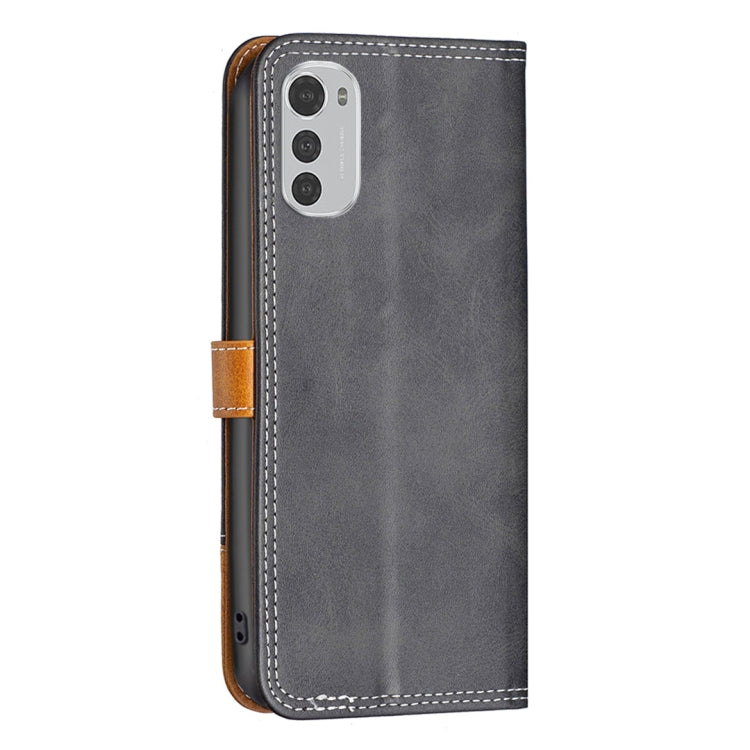 Gray leather folio phone case with tan button strap and double-stitched border