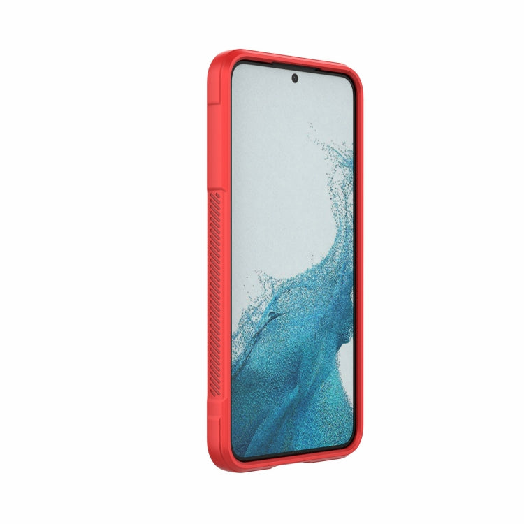 Red rugged phone case with raised edges and textured back shield design