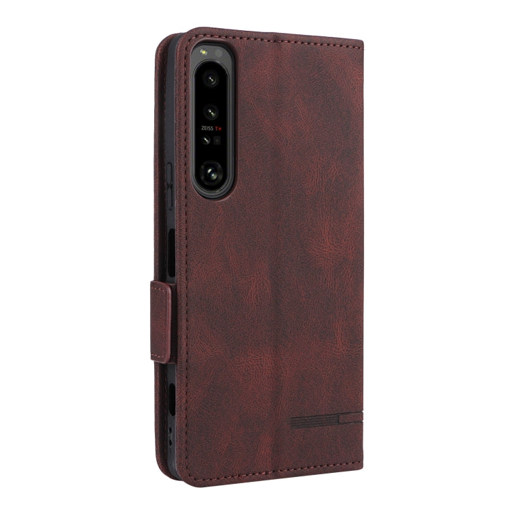 Brown leather flip phone case with camera cutout and side strap