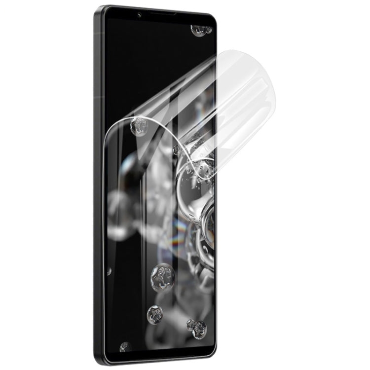 Curved hydrogel screen protector film on smartphone display, showing transparent coverage.