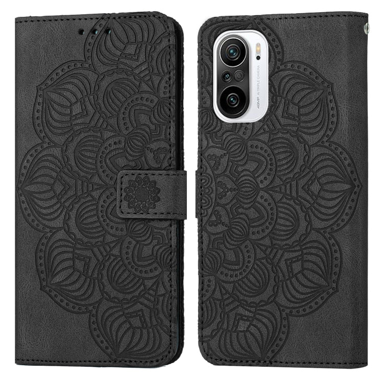 Black embossed flip leather phone case with mandala pattern and magnetic strap closure.