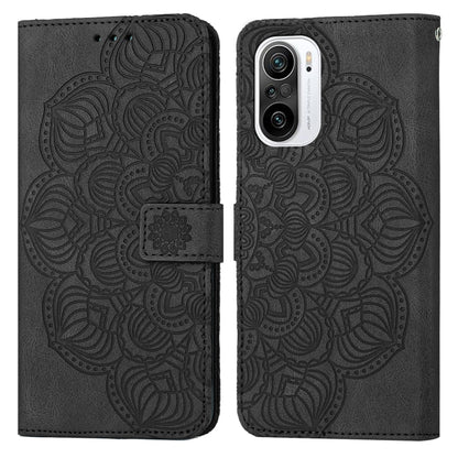 Black embossed flip leather phone case with mandala pattern and magnetic strap closure.