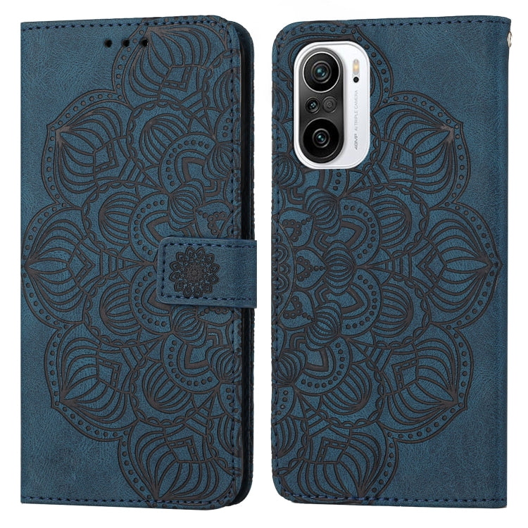 Blue embossed flip leather phone case with mandala pattern and magnetic strap closure.