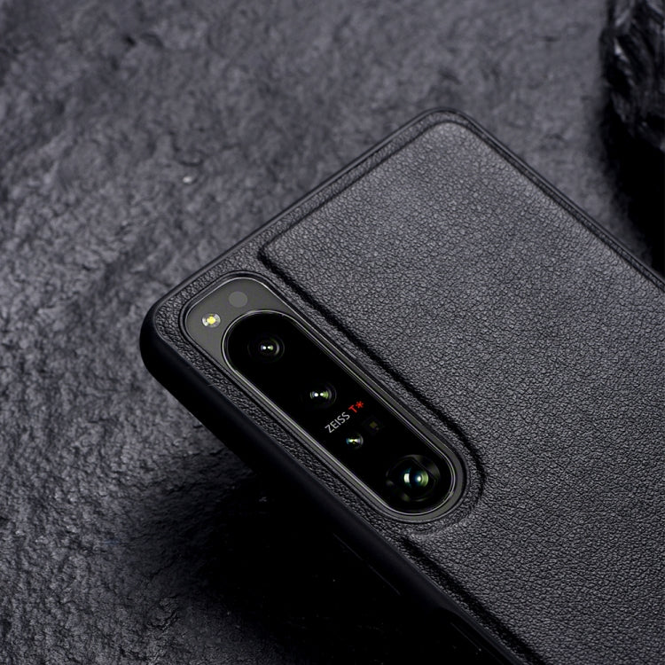 Black leather-texture protective phone case with camera cutout and holder area on back.