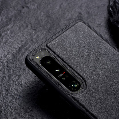 Black leather-texture protective phone case with camera cutout and holder area on back.