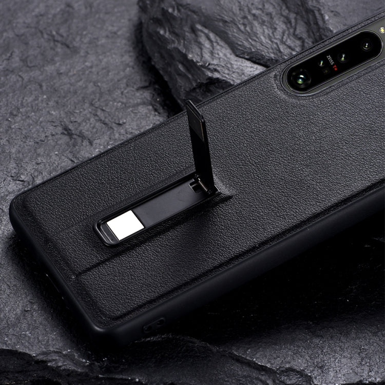 Black phone case with metal holder extended from the back for viewing support.