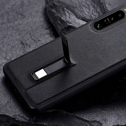 Black phone case with metal holder extended from the back for viewing support.