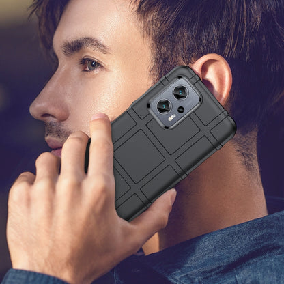 Black rugged shockproof TPU phone case held to ear with camera cutout