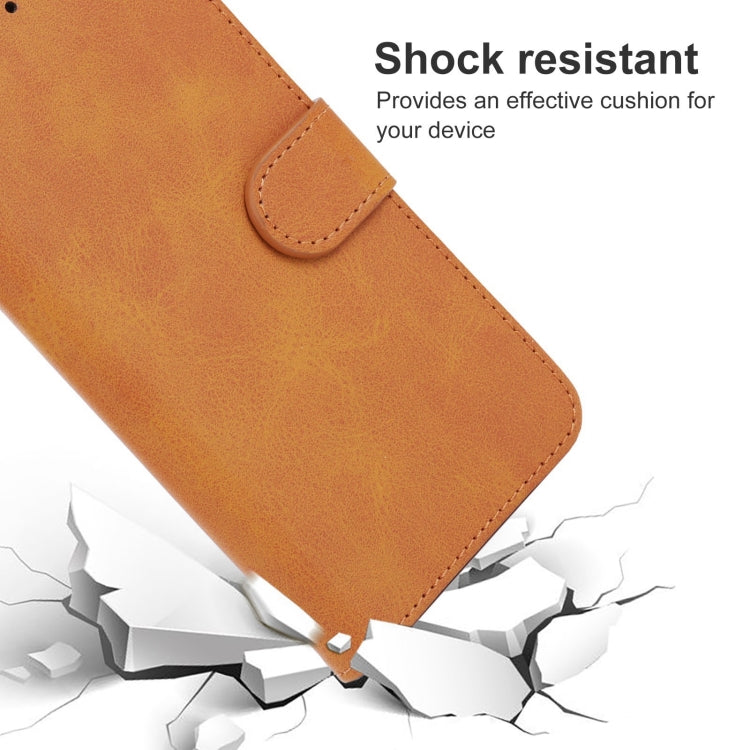 Brown leather flip phone case with curved tab closure and stitched edges