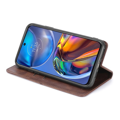 Brown magnetic flip phone case worn like a stand, showing screen through opening