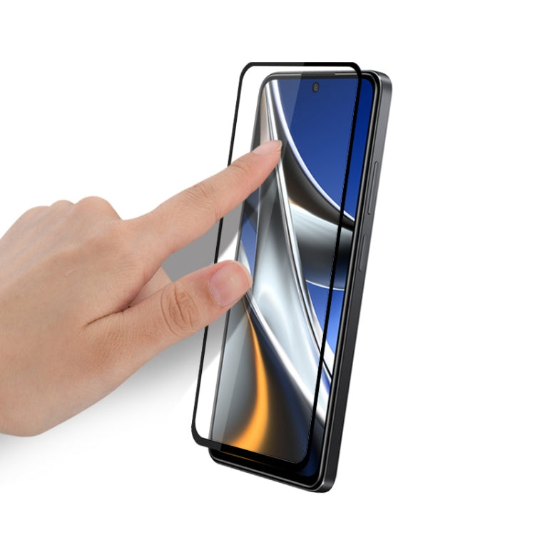 Tempered glass screen protector film with black edges, placed on smartphone screen